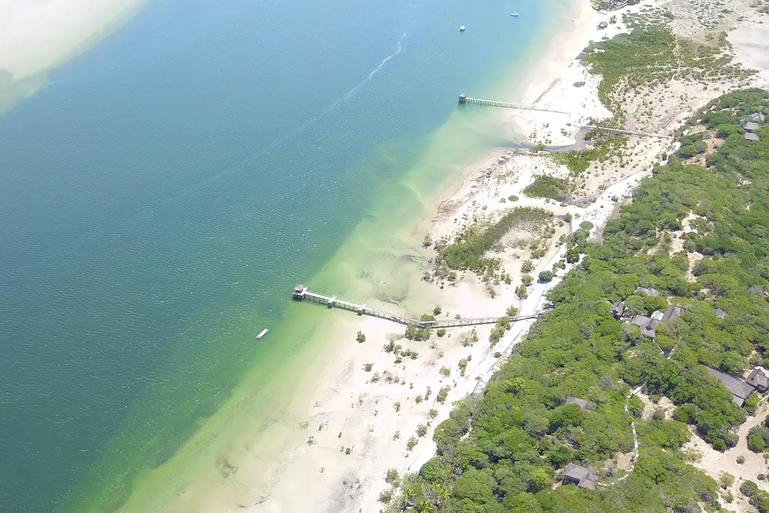 Perfect Hideaways real estate property: A waterway alongside coastal wetlands and mangroves, featuring multiple docks for water access, and a sustainable guest lodge. The Sanctuary Private Reserve, Mozambique.