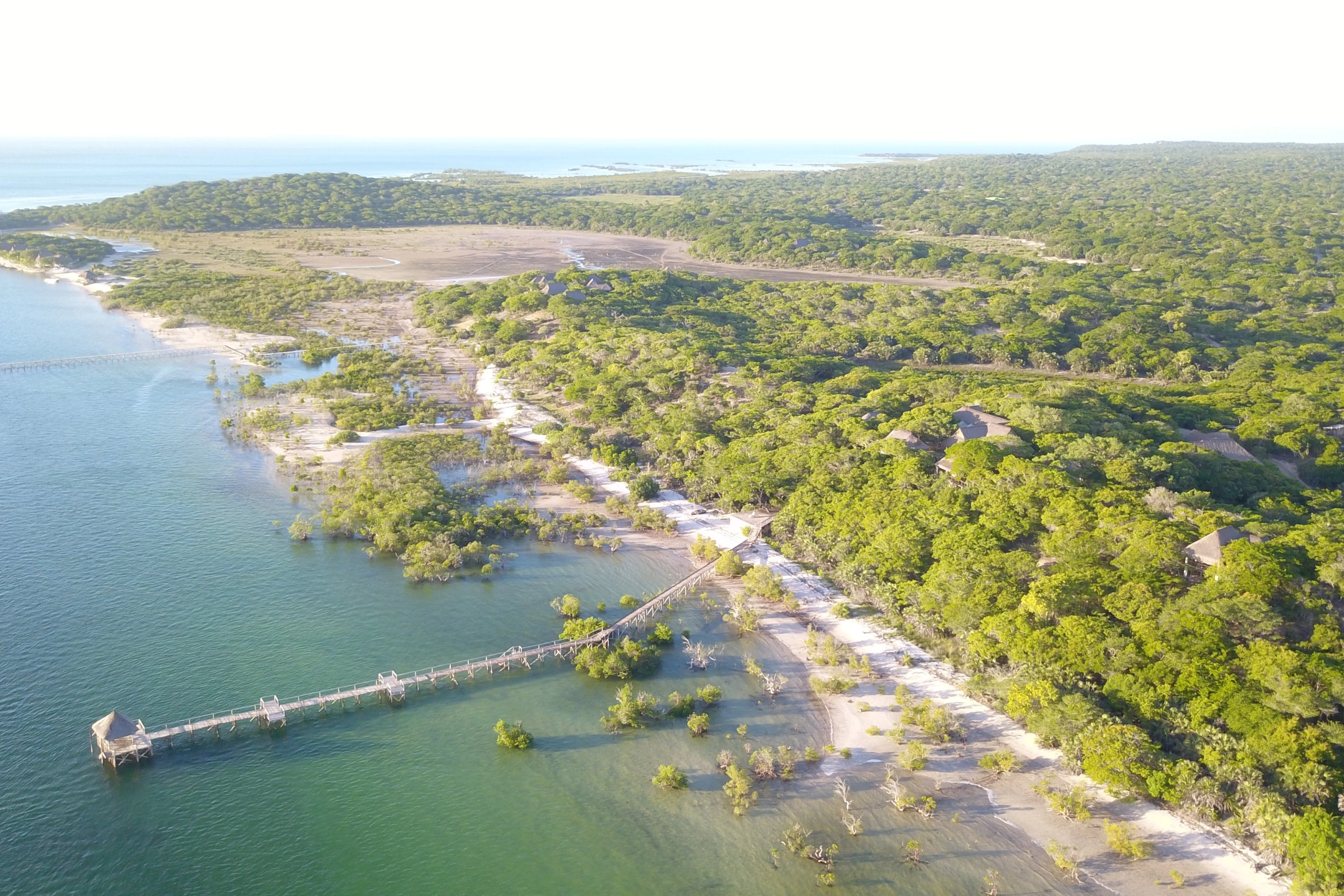 Perfect Hideaways real estate property: A coastal lodge amongst the lush vegetation, featuring views of the expansive Mozambican coastline, and a nearby dock for water activities. The Sanctuary Private Reserve, Mozambique.