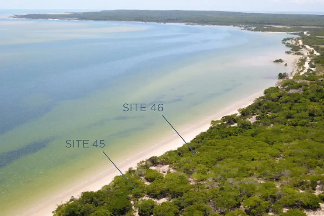 Perfect Hideaways real estate property: A stretch of coastline on the San Sebastian Peninsula, with text pointing to two plots of land for sale. The Sanctuary Private Reserve, Mozambique.