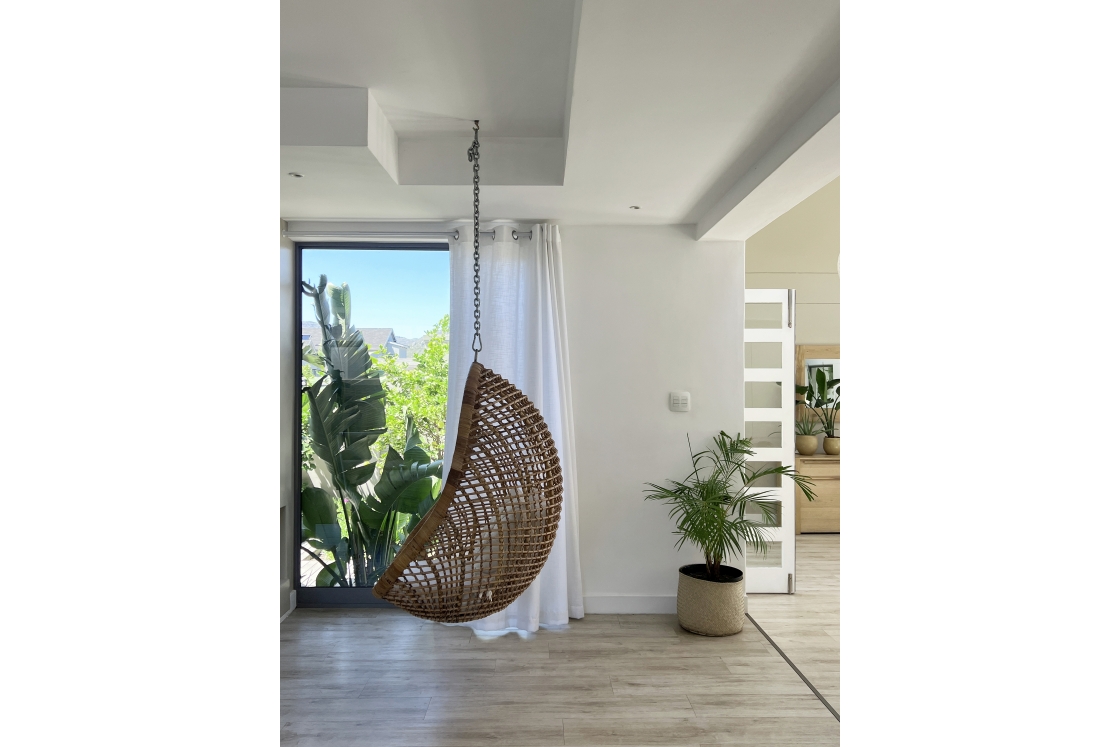 A hanging swing chair in a modern home within the living space.