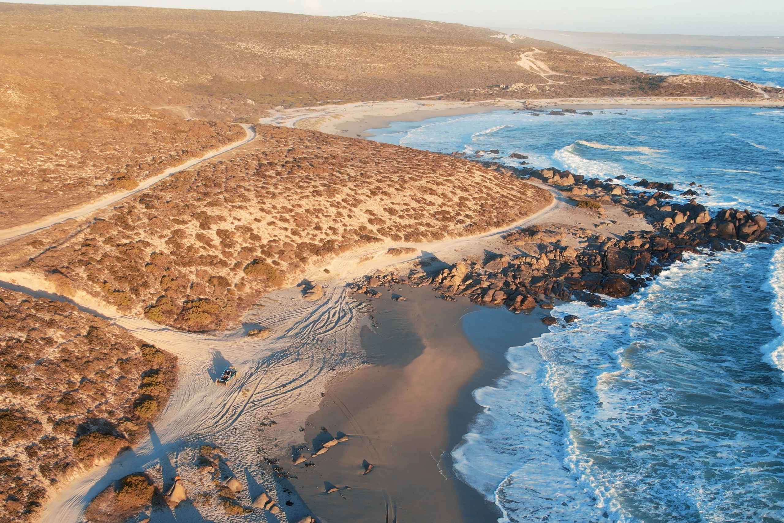 Perfect Hideaways property for sale: A stretch of coastline on the West Coast of South Africa. Dry vegetation with sand trail and tyre tracks. Trekoskraal, Paternoster.