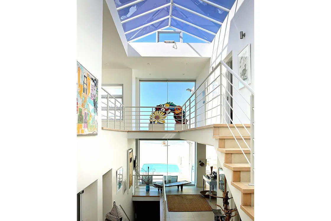 Perfect Hideaways real estate property: A view of the interior of a beach house, with glass panes in the ceiling allowing light to filter through to all corners of the home. Roga Rock, Plettenberg Bay.