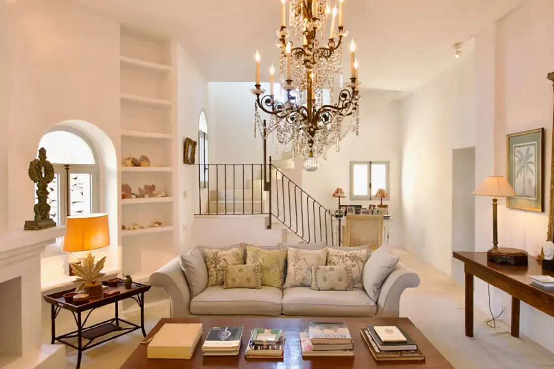 Perfect Hideaways real estate property: A grand interior of the Finca home, which showcases the elegance of Spanish living through its luxury furniture, and intricate ceiling chandelier. Ibiza, Ibizan Finca.