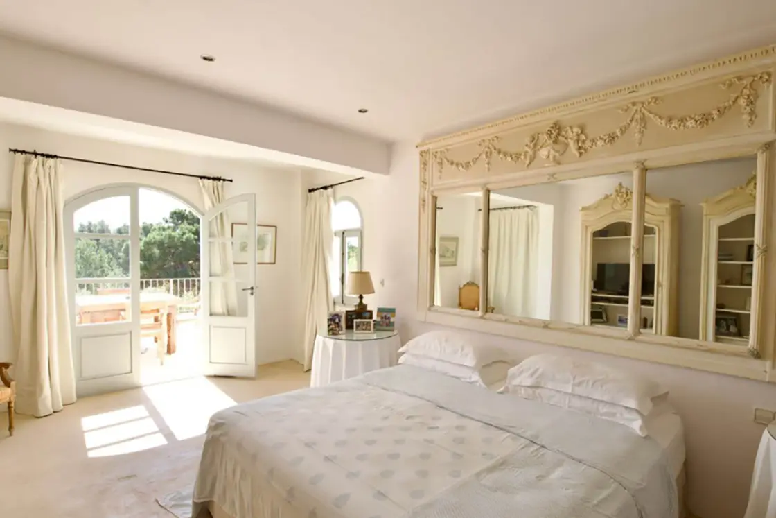 Perfect Hideaways real estate property: A grand bedroom area in the Finca home, featuring a double bed with an ornate mirror detail between the bedside tables. Ibiza, Ibizan Finca.