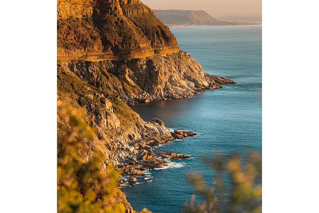 Perfect Hideaways real estate property: A scenic photo of the Atlantic ocean below Chapman's Peak drive during 'golden hour'. The Berg Manor and Villas, Hout Bay.