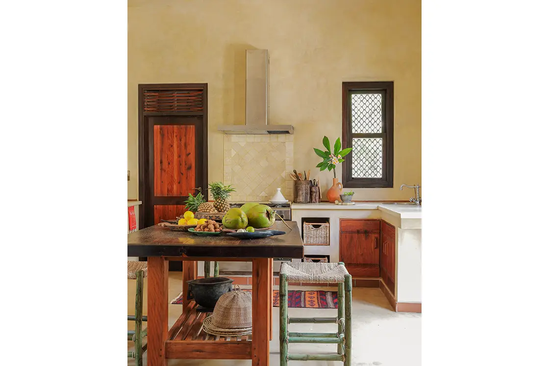 Perfect Hideaways real estate property: A kitchen area with a central table and counter space, showcasing the Moroccan architecture of the villa. Villa Tanga, Benguerra Island.