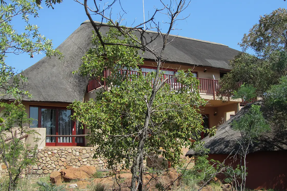 Perfect Hideaways real estate property: The exteriors of the thatch lodge showing the balcony and verandahs. Mabula Game Reserve, Limpopo.