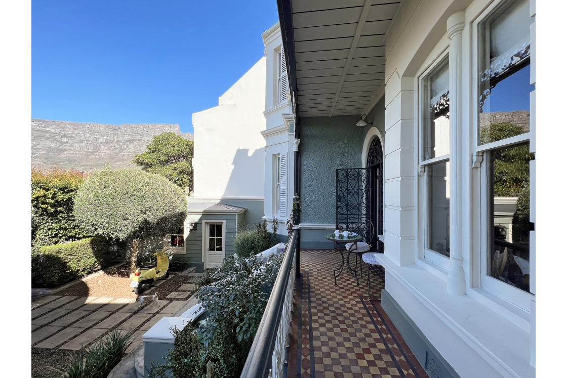 The front stoep with retro patterned floors and wrought iron coffee table.