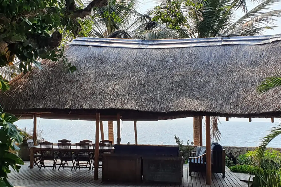 Perfect Hideaways real estate property: A dining area on a deck, with a gazebo covering, surrounded by Mozambican vegetation. Villa 1b Beach House, Vilanculos.