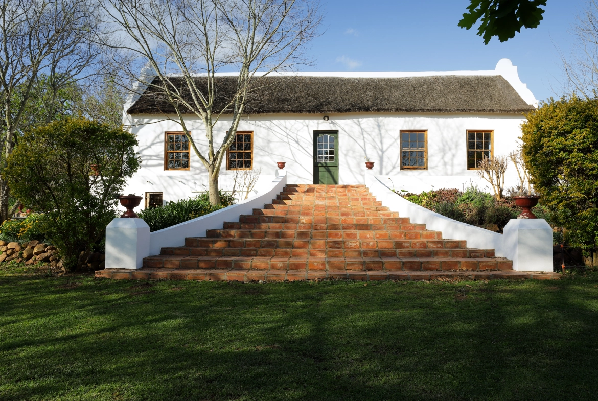 Perfect Hideaways real estate property: Terracotta steps leading up to the Cape-Dutch farm style home. Large garden area. Zeekoegat Farm in Riversdale.