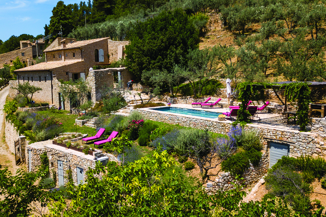 Perfect Hideaways real estate property: A restored villa with natural stone architecture, featuring an outdoor pool area surrounded by an olive grove. Casa Di Led in Spoleto.