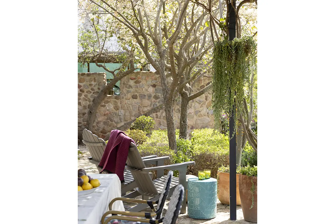 Perfect Hideaways real estate property: An outdoor seating area, featuring a covered veranda with two chairs and a side table. Barncroft in Napier.