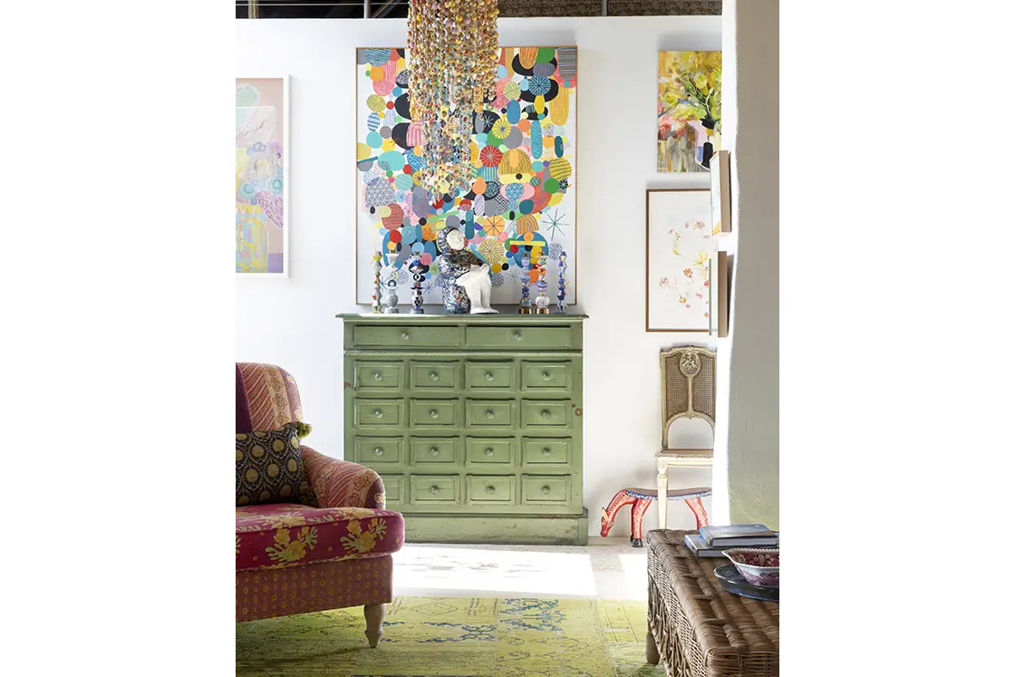 Perfect Hideaways real estate property: The entrance hall, featuring a green cabinet with multiple shelves, a patterned green carpet, and a contemporary chandelier. Barncroft in Napier.