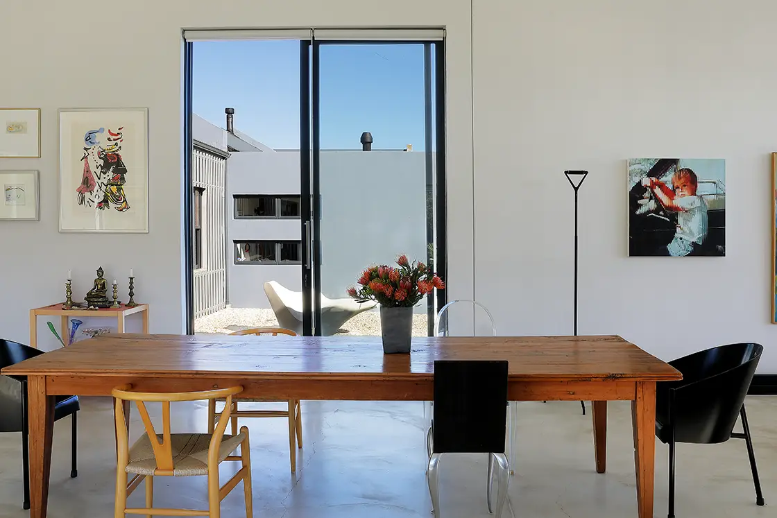 Perfect Hideaways real estate property: A dining room featuring a wooden table surrounded by different types of chairs. HaesFarm in Stanford.