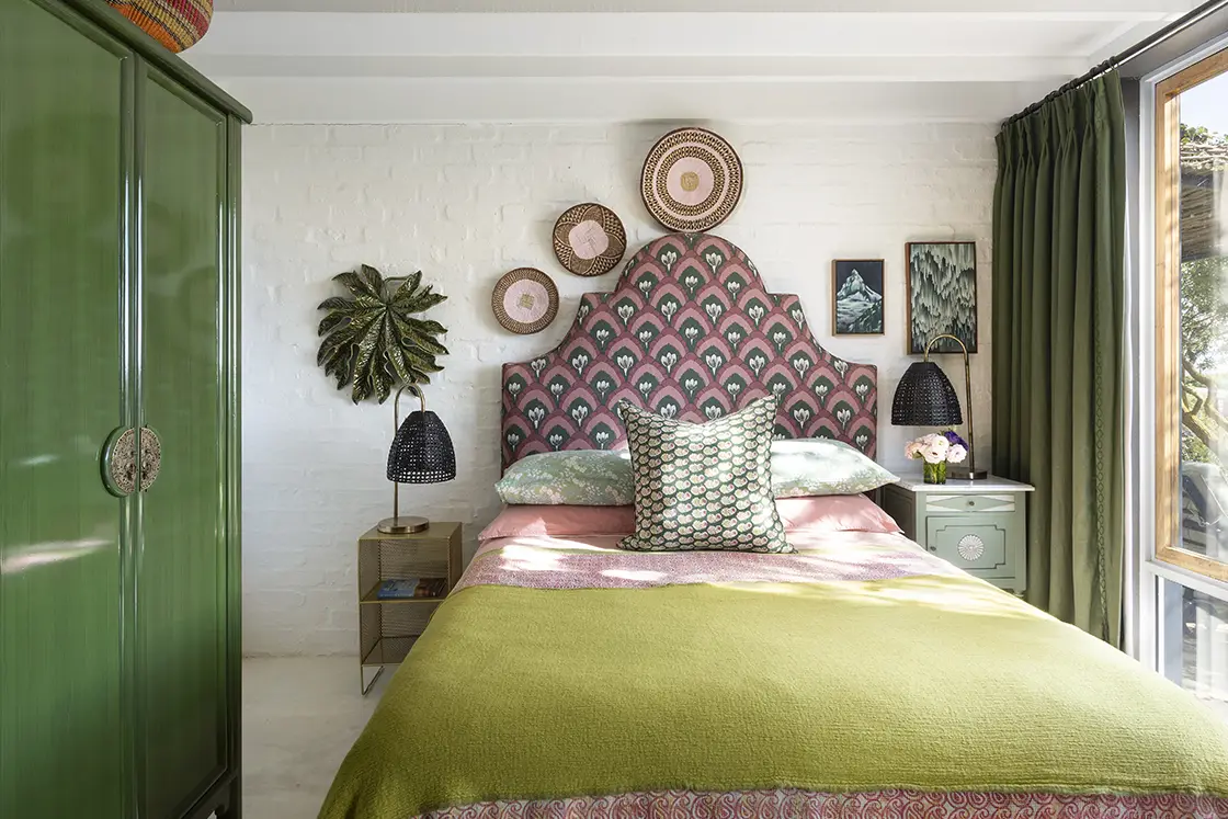 Perfect Hideaways real estate property: Bedroom suite with decorative pink double bed and gabled headboard, as well as green accent tones which complement the bedroom's eclectic style. Barncroft in Napier.