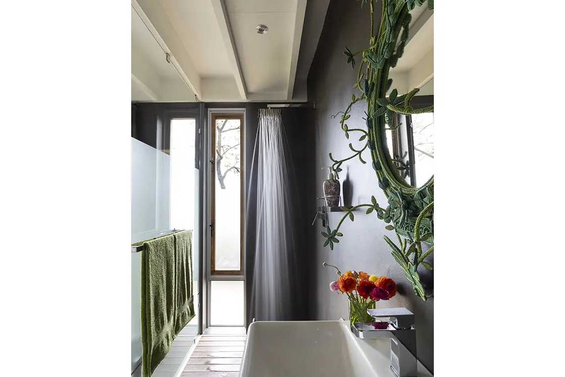 Perfect Hideaways real estate property: A bathroom, featuring a rain shower head, a basin and an ornate iron mirror. Barncroft in Napier.