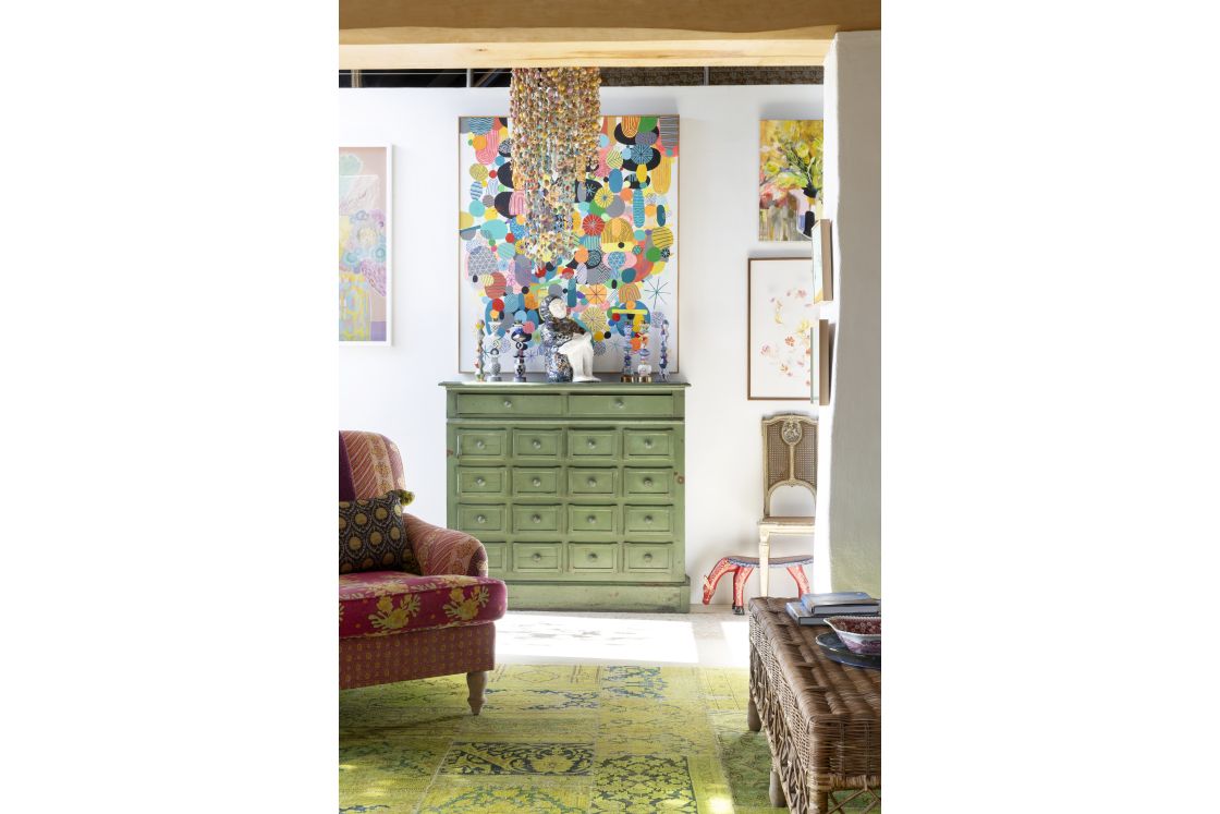 Entrance hall with central green cabinets, contemporary lighting feature, and green cabinet. Overberg.