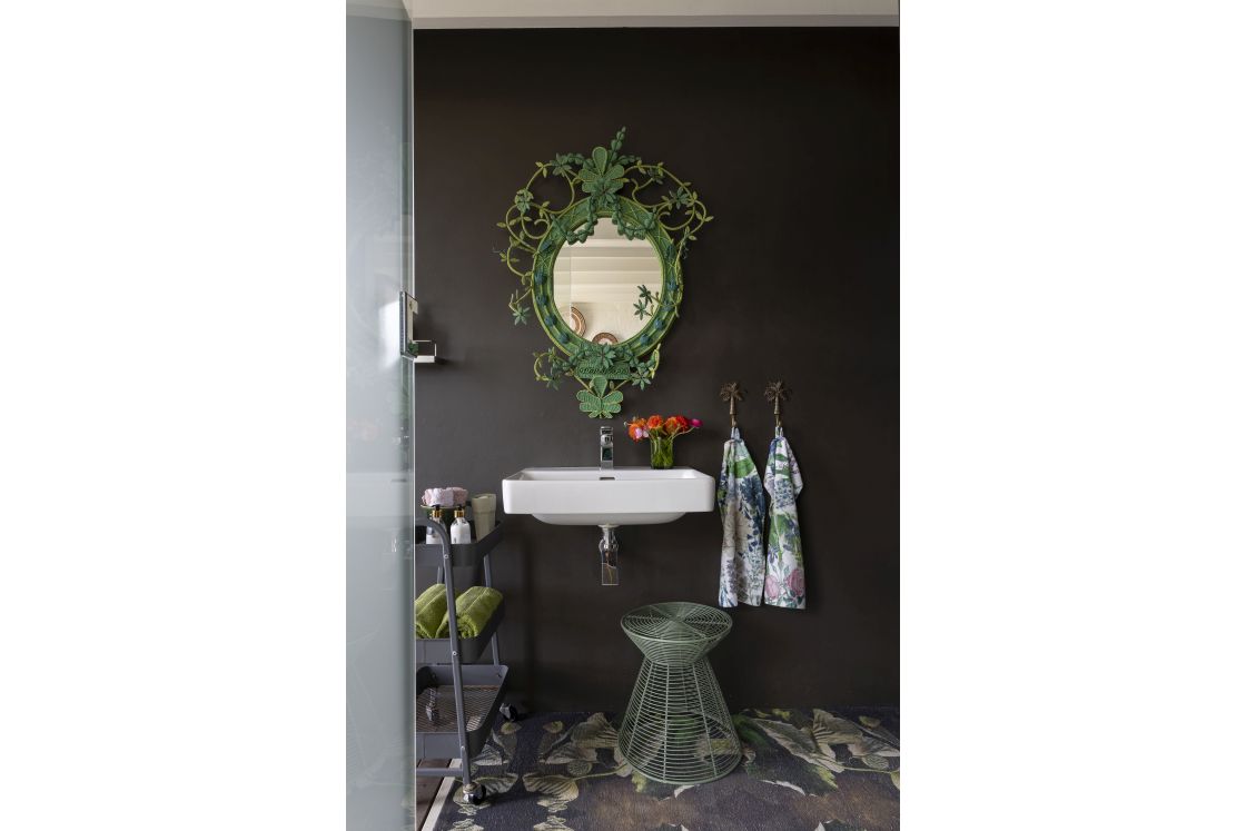 Floating basin with ornate iron mirror, mobile bathroom storage unit. Overberg.