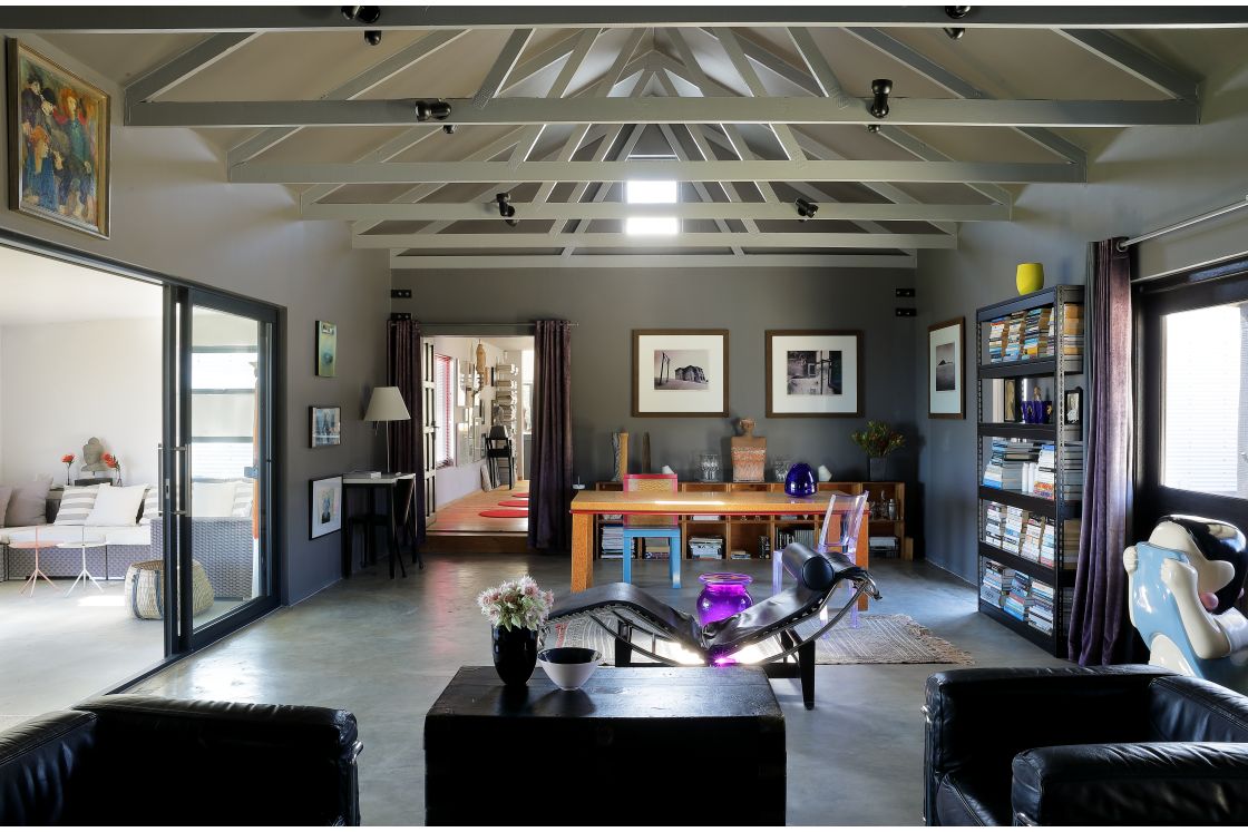 An expansive living room with a lofty ceiling and a contemporary dining area.