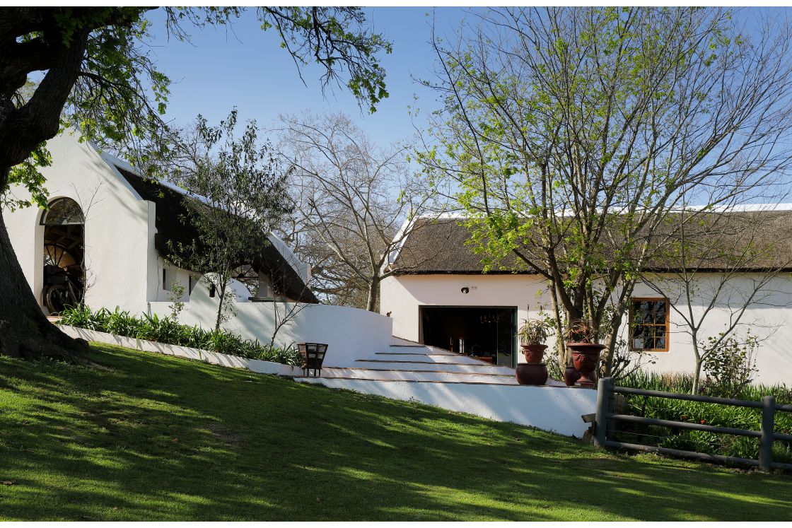 Cape Dutch property with outdoor fireplace, terracotta steps and large garden area. Garden Route.