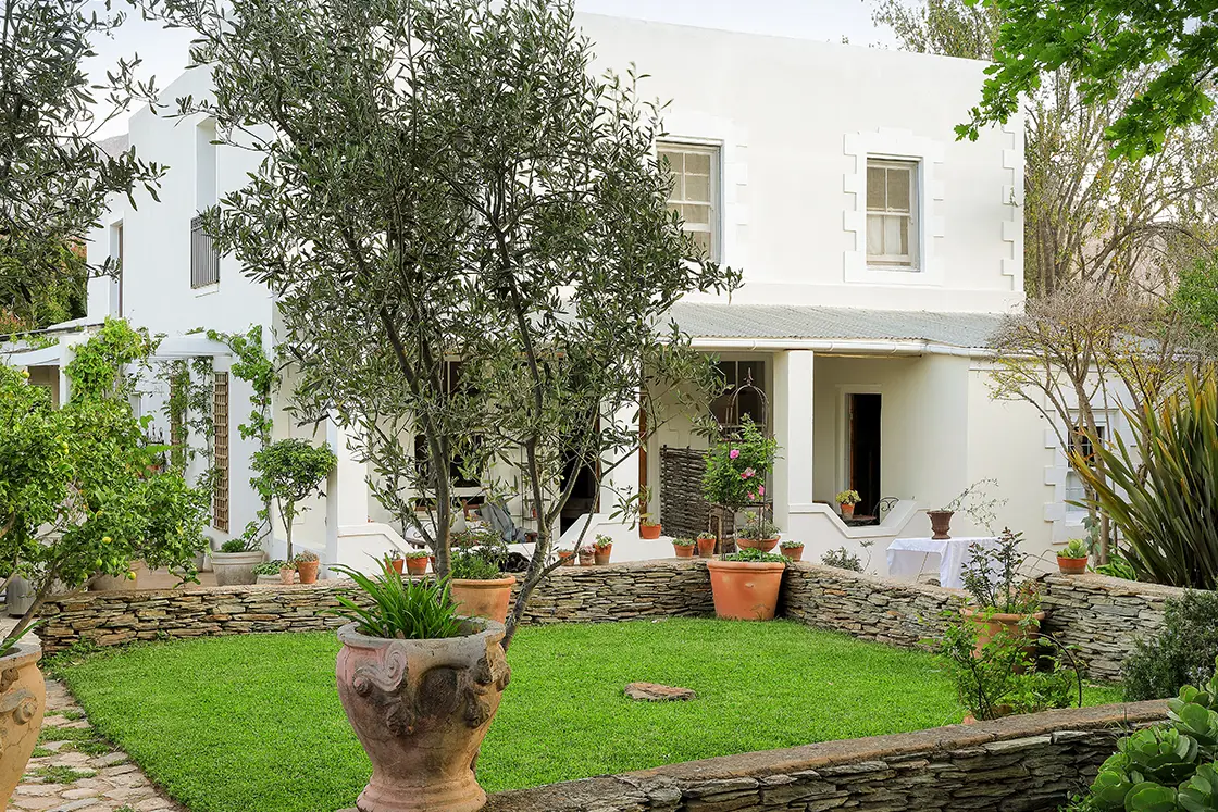 Perfect Hideaways real estate property: A manicured corner of the garden beside a white heritage home in Barrydale, Western Cape. The White House in Barrydale.