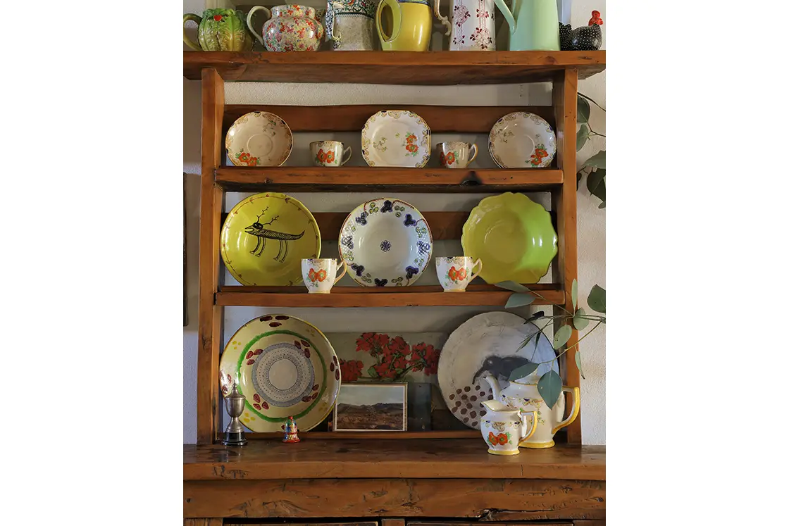 Perfect Hideaways real estate property: Decorative wooden shelving serves to display ornate plating and antique trinkets. The White House in Barrydale.