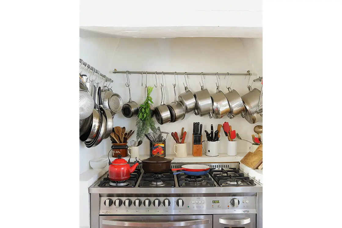 Perfect Hideaways real estate property: Many kitchen utensils line the walls above a stove top and oven unit. The White House in Barrydale.