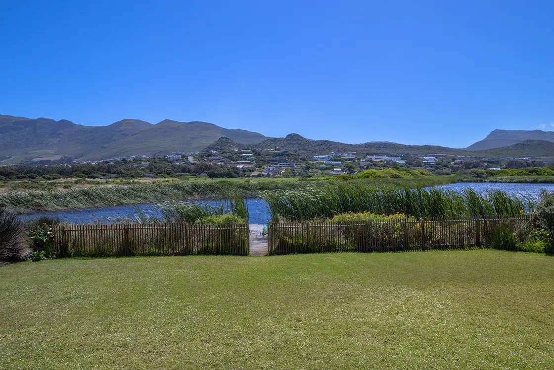 Perfect Hideaways property for sale: A well-kept lawn outside a residence for sale in the Southern Peninsula area of Cape Town, featured on a natural island. Waterside. Noordhoek.