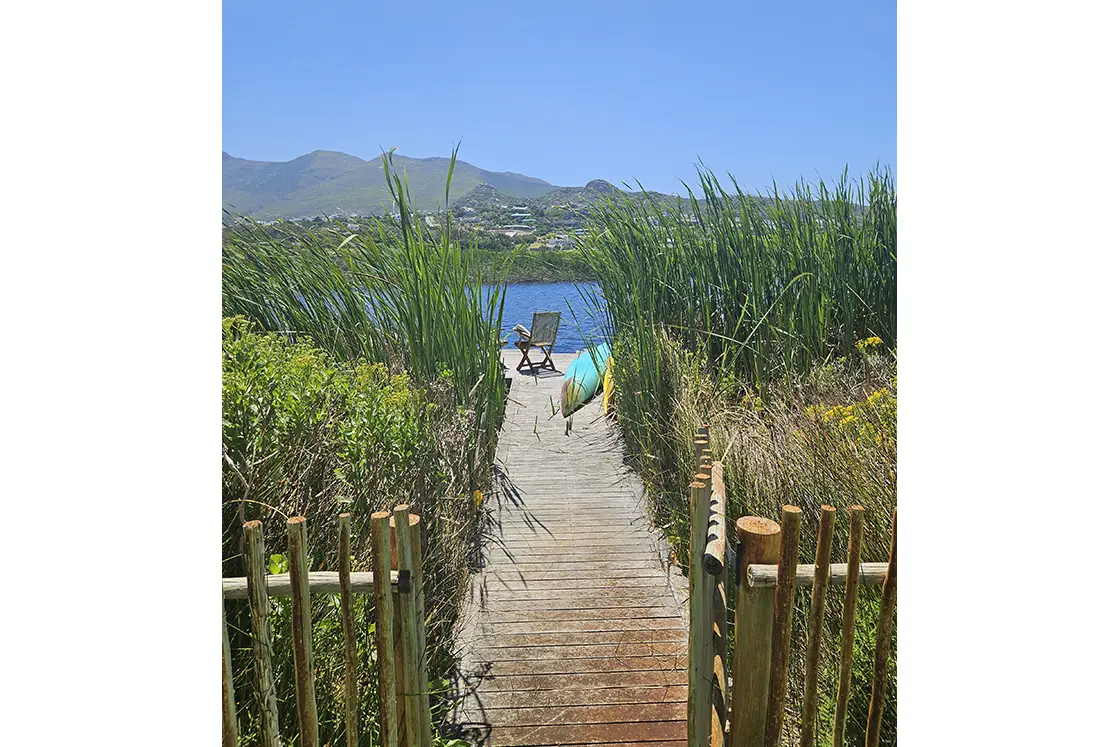 Perfect Hideaways property for sale: A pathway leading to the river, which features a private deck, accessible from a gate at the foot of the garden. Waterside. Noordhoek.